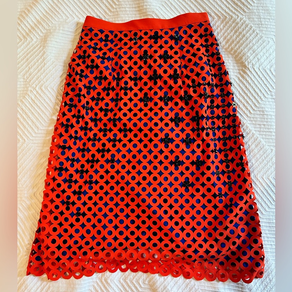 Knee-length skirt with texture and embellishments.